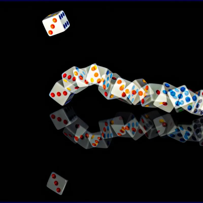Long-exposure trail of a rolling die reflected on a glossy black surface